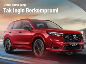 Honda CRV HEV merah terlihat dari depan samping, menonjolkan desain aerodinamis, lampu LED, dan gril sporty.
