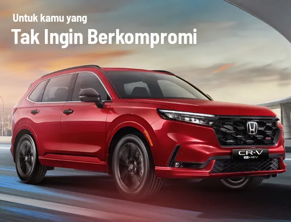 Honda CRV HEV merah terlihat dari depan samping, menonjolkan desain aerodinamis, lampu LED, dan gril sporty.