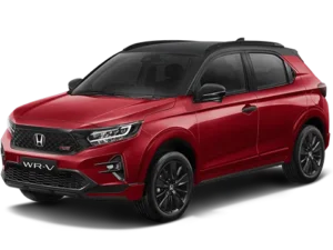 Mobil Honda WR-V berwarna merah cerah diparkir di luar ruangan.